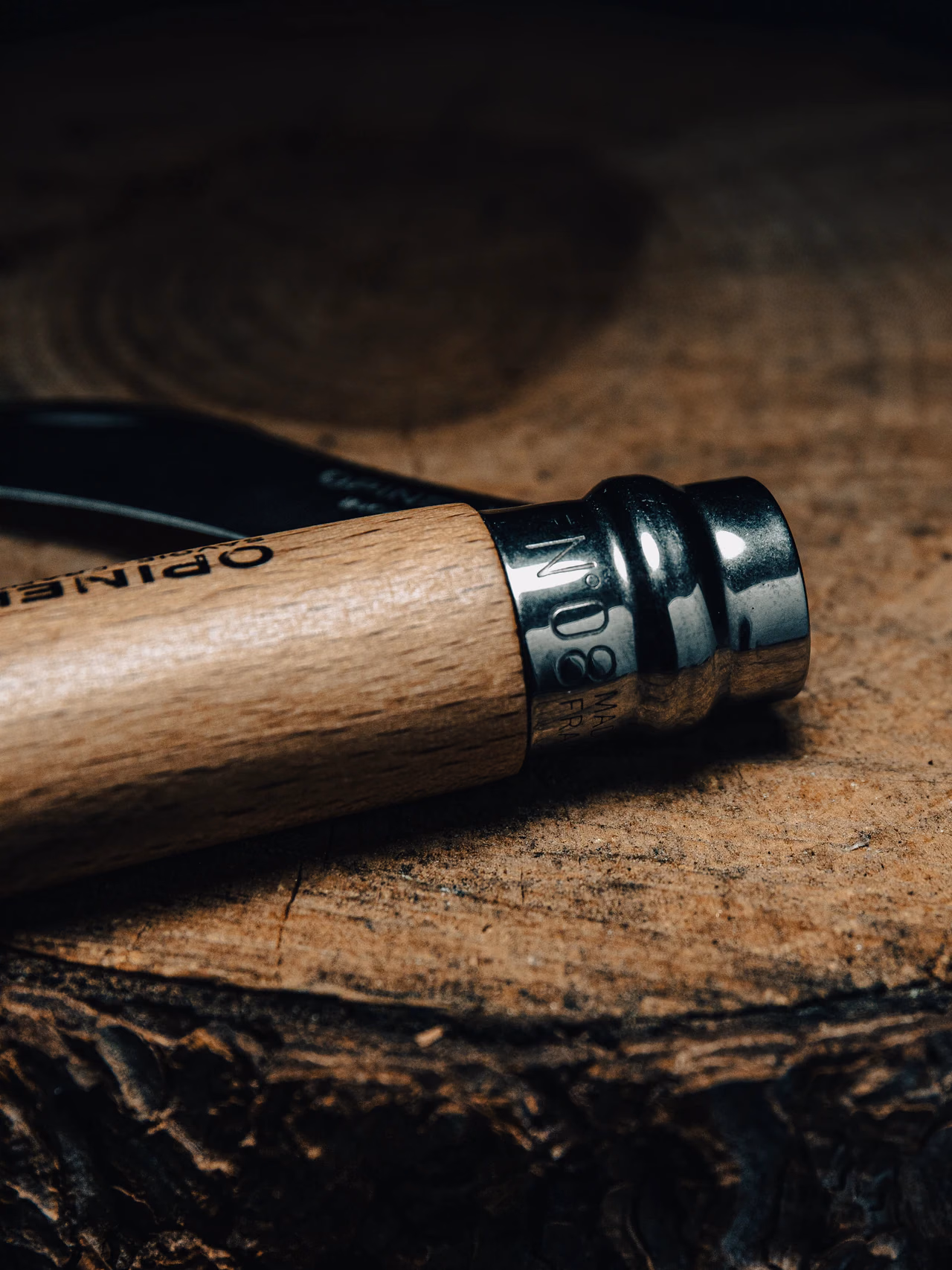 Detalle de madera y metal de una navaja sobre una superficie rugosa